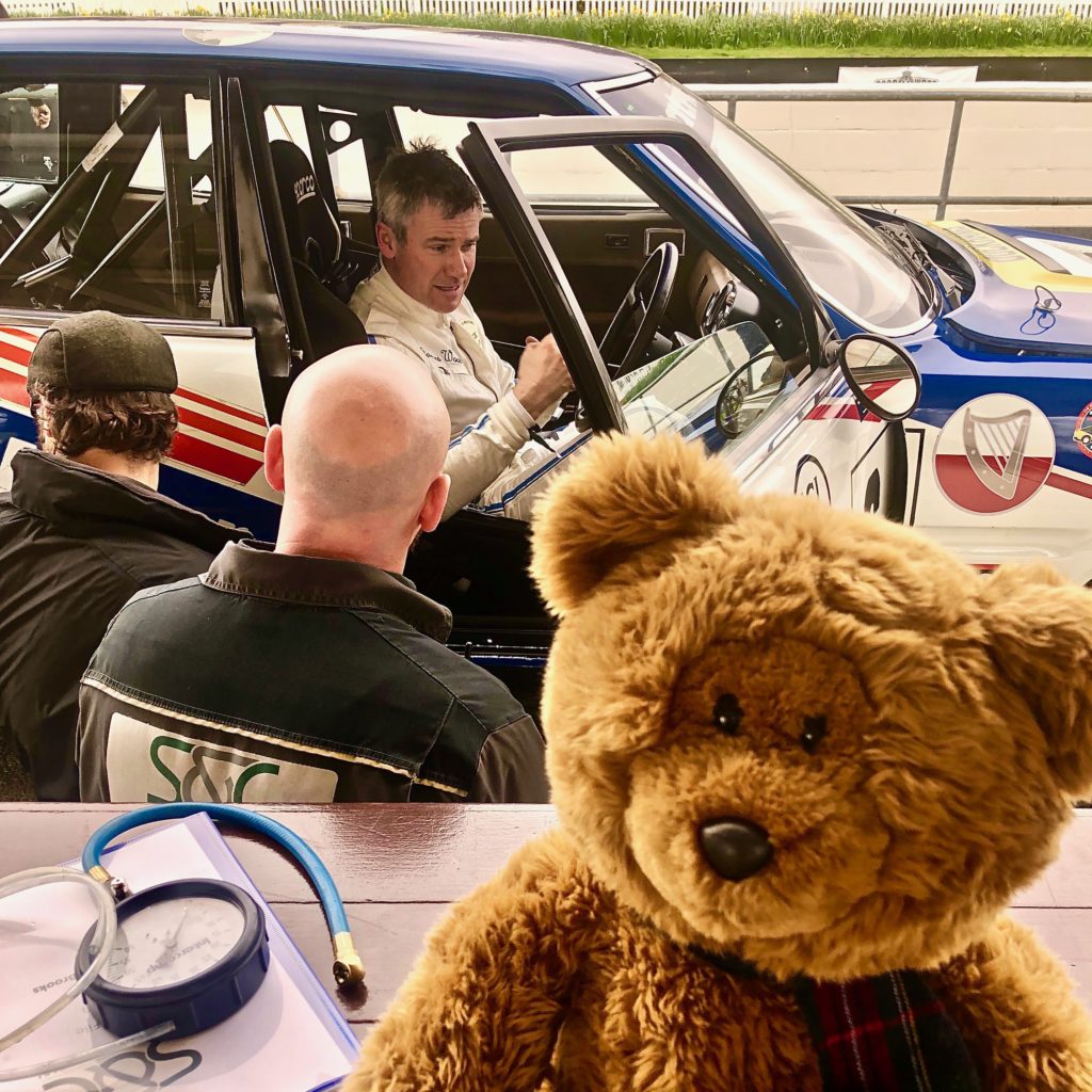 James Wood in the Rover SD1 with Hemel Bear on the pit counter, during practice for the Goodwood 77MM. Photo by Marcia White for Join The World Magazine.