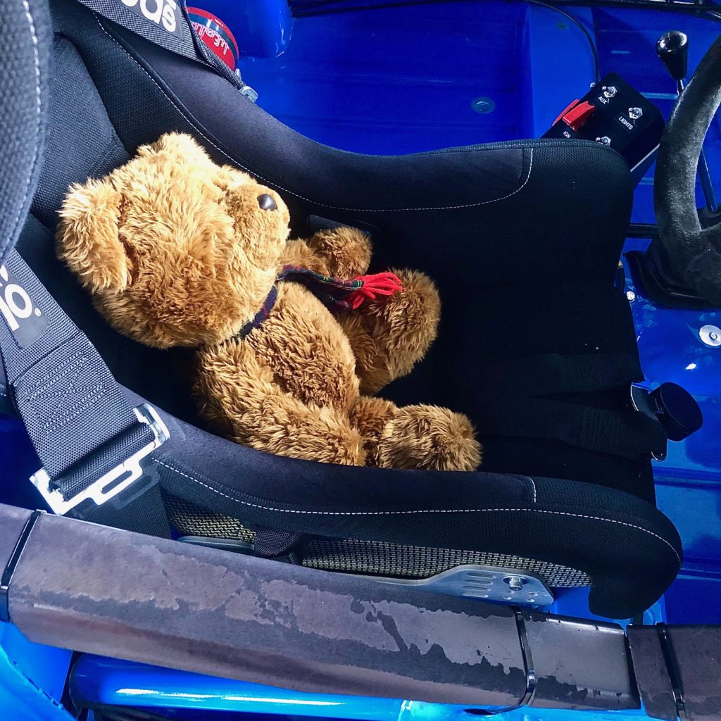 Hemel Bear sitting in the cockpit of the Sime Racing Mini, in the paddock at Goodwood Motor Circuit, during practice for the 77th Members Meeting #77MM.